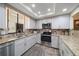 Modern kitchen with stainless steel appliances and granite countertops at 50 Coe Rd # 322, Belleair, FL 33756
