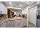 Modern kitchen with granite countertops and stainless steel appliances at 50 Coe Rd # 322, Belleair, FL 33756