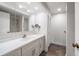 Bathroom with white vanity, large mirror, and shower at 50 Coe Rd # 322, Belleair, FL 33756