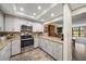 Bright kitchen featuring stainless steel appliances and white cabinets at 50 Coe Rd # 322, Belleair, FL 33756