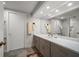 Modern bathroom with gray vanity, double sinks, and a walk-in shower at 50 Coe Rd # 322, Belleair, FL 33756