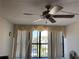 Living room with window coverings, ceiling fan, and water views at 255 Dolphin Pt # 909, Clearwater, FL 33767