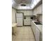 Efficient kitchen featuring white cabinets, appliances, and tile flooring at 255 Dolphin Pt # 909, Clearwater, FL 33767