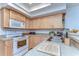 Updated kitchen with light wood cabinets and stainless steel appliances at 5333 Cobblestone Ct, Wesley Chapel, FL 33543
