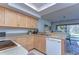 Bright kitchen boasts light wood cabinets, granite countertops, and modern appliances at 5333 Cobblestone Ct, Wesley Chapel, FL 33543