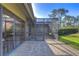 Private patio with sliding glass doors and screened enclosure at 5333 Cobblestone Ct, Wesley Chapel, FL 33543