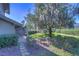 Landscaped backyard with lush greenery and mature trees at 5333 Cobblestone Ct, Wesley Chapel, FL 33543