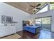 Bedroom with dark wood floors, vaulted ceilings and access to a balcony at 5333 Cobblestone Ct, Wesley Chapel, FL 33543