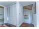 Hallway with wood floors and white closet doors at 5333 Cobblestone Ct, Wesley Chapel, FL 33543