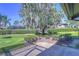 Backyard with lush landscaping and a large oak tree at 5333 Cobblestone Ct, Wesley Chapel, FL 33543