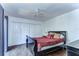 Sleigh bed in bedroom with dark wood floors and closet at 5333 Cobblestone Ct, Wesley Chapel, FL 33543