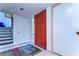 Inviting entryway with a bright orange door and tiled floor at 5333 Cobblestone Ct, Wesley Chapel, FL 33543