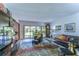 Comfortable living room with a large TV, leather furniture, and backyard access at 5333 Cobblestone Ct, Wesley Chapel, FL 33543