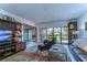 Relaxing living room with leather furniture, large TV, and access to a private patio at 5333 Cobblestone Ct, Wesley Chapel, FL 33543