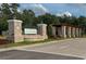 Community entrance with brick pillars and signage at 4729 Majestic Hills Loop, Brooksville, FL 34601