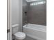 Bathroom with a shower/tub combo and gray tile at 4729 Majestic Hills Loop, Brooksville, FL 34601