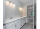 Double vanity bathroom with modern finishes and a walk-in shower at 4729 Majestic Hills Loop, Brooksville, FL 34601