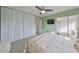 Bedroom with a ceiling fan, large closet, and sliding glass doors to balcony at 7701 Starkey Rd # 322, Seminole, FL 33777