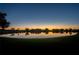 Peaceful lake view at sunset with community homes reflecting in the water at 5139 Hill Dr, Zephyrhills, FL 33542