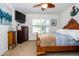 Bedroom featuring a bed with a wooden frame, a TV, a dresser and a view of the pool at 1523 Glen Grove Loop, Wesley Chapel, FL 33543
