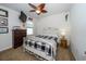 Comfortable bedroom with plaid bedding, ceiling fan, and TV, perfect for relaxing at 1523 Glen Grove Loop, Wesley Chapel, FL 33543