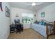 Cozy bedroom with a bed, desk, and window offering natural light, creating a comfortable space at 1523 Glen Grove Loop, Wesley Chapel, FL 33543