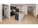 Bright kitchen boasts an island with granite countertops and sleek black appliances at 1523 Glen Grove Loop, Wesley Chapel, FL 33543