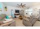 Comfortable living room with tile floors, ceiling fan, TV, and display cabinet, perfect for relaxing or entertaining at 1523 Glen Grove Loop, Wesley Chapel, FL 33543