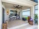 Relaxing outdoor patio with ceiling fan, comfortable seating, and tropical decor for enjoying the outdoors at 1523 Glen Grove Loop, Wesley Chapel, FL 33543