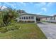 Single-wide manufactured home with carport and landscaped yard at 198 Philadelphia Blvd # 11, Palm Harbor, FL 34684