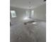 Unfinished bedroom featuring three windows with a view to the outside at 3403 W Leona St, Tampa, FL 33629