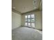 Bedroom featuring large windows and tray ceiling with recessed lighting at 3403 W Leona St, Tampa, FL 33629