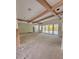 Unfinished living room showcasing a beamed ceiling and a large glass sliding doors leading to the outside at 3403 W Leona St, Tampa, FL 33629