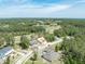 Stunning aerial view of the neighborhood featuring lush greenery and a golf course and pond at 4880 Hickory Oak Dr, Brooksville, FL 34601