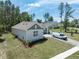 Attractive home exterior, featuring well-kept landscaping and spacious driveway with ample parking at 4880 Hickory Oak Dr, Brooksville, FL 34601