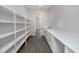 Bright walk-in pantry with open shelving on one side and cabinets and a sink on the other at 4880 Hickory Oak Dr, Brooksville, FL 34601