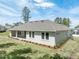 A beautiful back exterior featuring well-maintained lawn and tastefully landscaped garden beds at 4880 Hickory Oak Dr, Brooksville, FL 34601
