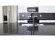 Modern kitchen with stainless steel appliances and black countertops at 9085 Dorsey St, Spring Hill, FL 34608