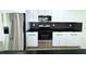 Modern kitchen with stainless steel appliances and black countertops at 9085 Dorsey St, Spring Hill, FL 34608