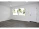 Living room with vinyl flooring, large windows, and white walls at 9085 Dorsey St, Spring Hill, FL 34608