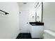 Updated bathroom with black and white tile and double vanity at 9085 Dorsey St, Spring Hill, FL 34608