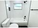 Clean bathroom with a bathtub, shower, and white tile at 9085 Dorsey St, Spring Hill, FL 34608