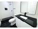 Stylish bathroom with black and white tile and walk-in shower at 9085 Dorsey St, Spring Hill, FL 34608