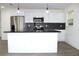 Modern kitchen with stainless steel appliances and a breakfast bar at 9085 Dorsey St, Spring Hill, FL 34608