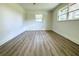Well-lit bedroom with large window and wood-look floors at 9085 Dorsey St, Spring Hill, FL 34608