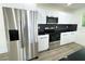 Modern kitchen with stainless steel appliances and black countertops at 9085 Dorsey St, Spring Hill, FL 34608