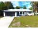 Single story home with driveway and landscaped lawn at 9085 Dorsey St, Spring Hill, FL 34608