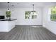 Modern kitchen with white cabinets, black countertops, and island at 9085 Dorsey St, Spring Hill, FL 34608