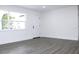 Spacious living room featuring gray vinyl flooring and large windows at 9085 Dorsey St, Spring Hill, FL 34608