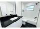 Modern bathroom with black and white tile and vanity at 9085 Dorsey St, Spring Hill, FL 34608